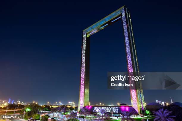 night view of  dubai frame, dubai, united arab emirates - city lights reflected on buildings speed stock pictures, royalty-free photos & images