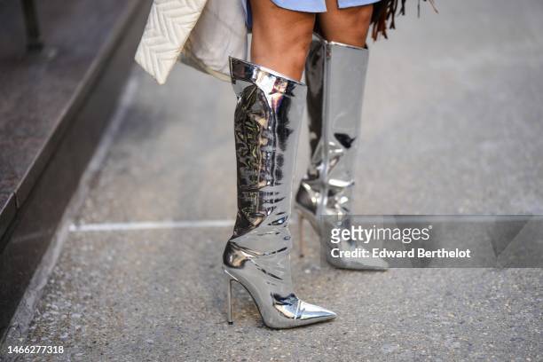 Ghizlane Sabbahe wears silver shiny varnished leather pointed heels knees boots / high boots, silver rings , outside Brandon Maxwell, during New York...
