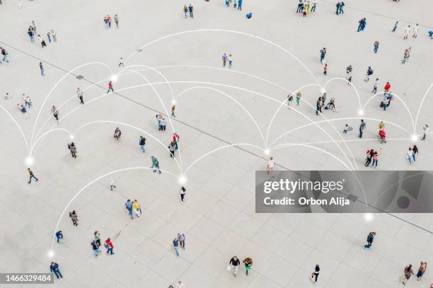 aerial view of crowd connected by lines - human connection stock pictures, royalty-free photos & images