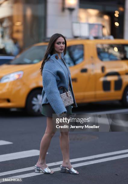 Andrea Sabotic seen wearing Tory Burch gold necklace, Tory Burch grey / blue oversize wool jacket, Tory Burch grey sleeveless short dress, Tory Burch...