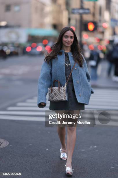 Andrea Sabotic seen wearing Tory Burch gold necklace, Tory Burch grey / blue oversize wool jacket, Tory Burch grey sleeveless short dress, Tory Burch...