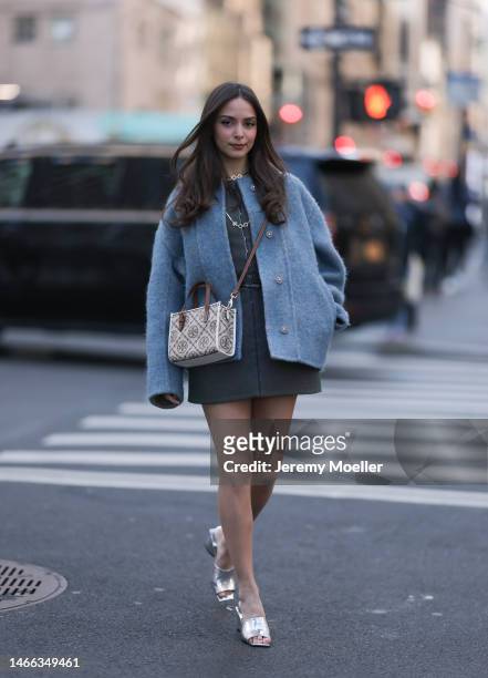 Andrea Sabotic seen wearing Tory Burch gold necklace, Tory Burch grey / blue oversize wool jacket, Tory Burch grey sleeveless short dress, Tory Burch...