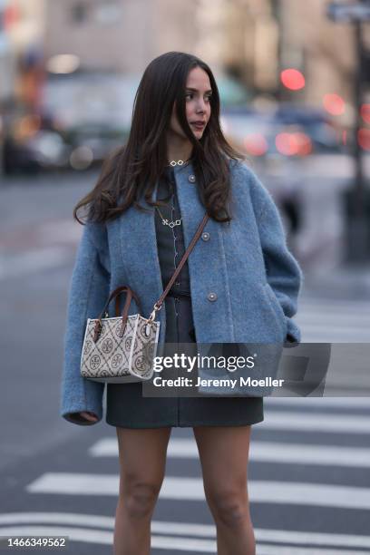 Andrea Sabotic seen wearing Tory Burch gold necklace, Tory Burch grey / blue oversize wool jacket, Tory Burch grey sleeveless short dress, Tory Burch...