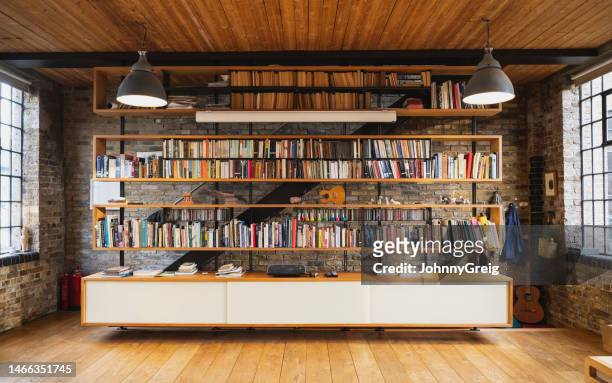 library bookshelves in modern warehouse loft conversion - bookcase stock pictures, royalty-free photos & images