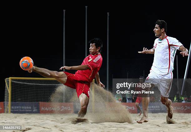 Hao Qiu of China wins the ball over Hassan Mobarhan Abdollahi of Iran during the Beach Soccer Men's Gold Medal Match between Iran and China on Day 5...