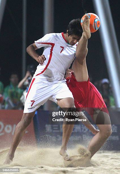 Weiming Cai of China competes for the ball against Mehran Morshedizadeh of Iran during the Beach Soccer Men's Gold Medal Match between Iran and China...