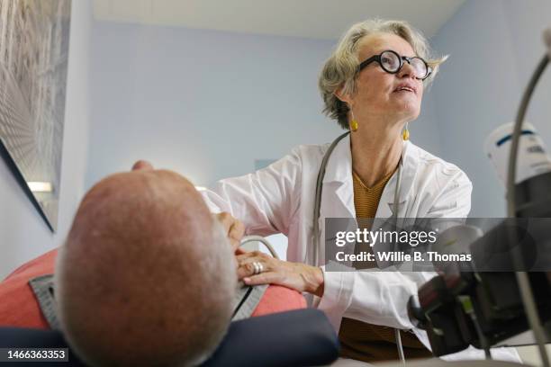 doctor conducting ultrasound examination - echokardiogramm stock-fotos und bilder