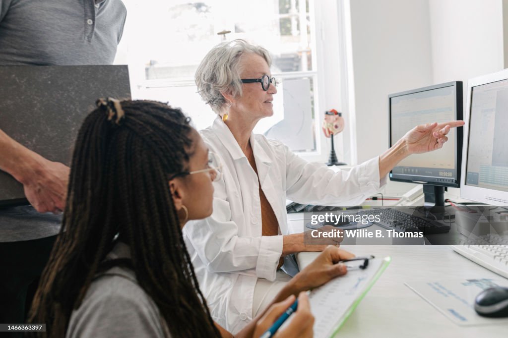 Doctors talking to MRI technicians about Magnetic Resonance Images MRI