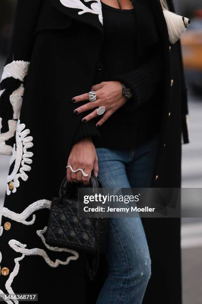 Corina Mihaila Larpin seen wearing Schiaparelli black long coat with white ornament print pattern, R13 dark blue destroyed jeans, Lady Dior black...