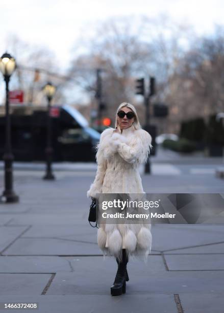 Corina Mihaila Larpin seen wearing Linda Fargo black sunglasses, Alexander McQueen white fur long coat, black leather leggings, YSL black leather...