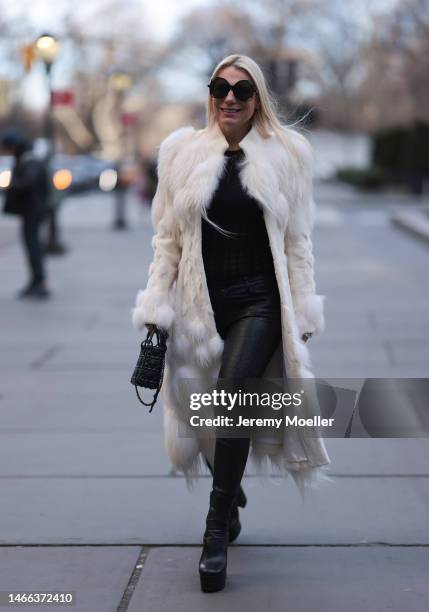 Corina Mihaila Larpin seen wearing Linda Fargo black sunglasses, Alexander McQueen white fur long coat, black leather leggings, YSL black leather...