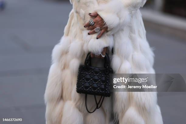 Corina Mihaila Larpin seen wearing Alexander McQueen white fur long coat, YSL black leather plateau / platform heels / boots, Lady Dior black leather...