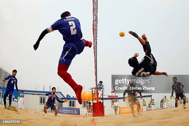 Mohammad Shukri Jaineh of Brunei Darussalam kicks over the net against Sornpithak Sriring of Thailand during the Beach Sepaktakraw Men's Regu...