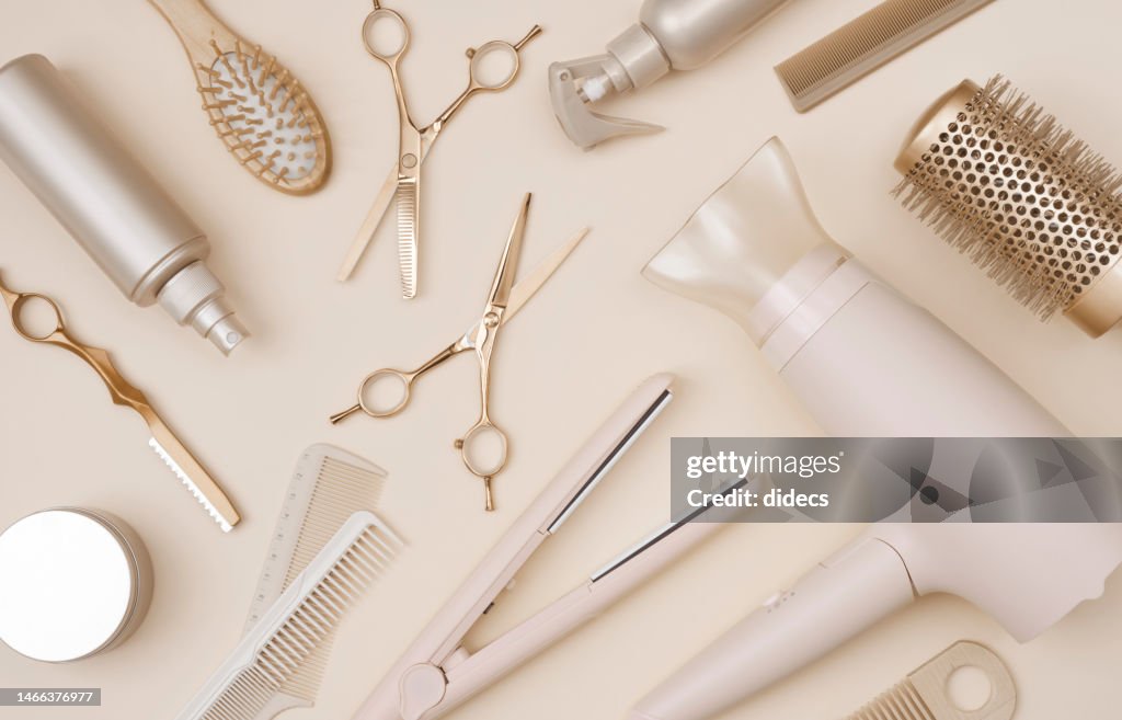 Various hairdresser tools flat lay on pink background top view