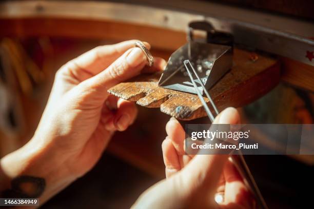 woman jeweller looking gemstone - joia imagens e fotografias de stock