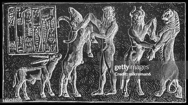 old engraved illustration of gil-gamesh (gilgamesh) and ea-bani fighting with monsters abull - ancient mesopotamian mythology - mesopotamian art stock pictures, royalty-free photos & images