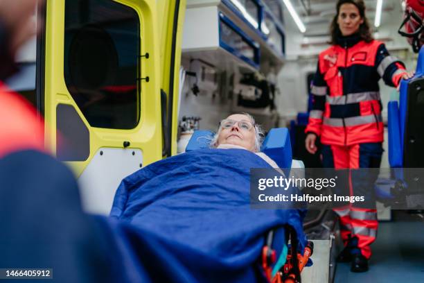 rescuers preparing patient for transportation. - hostess foto e immagini stock