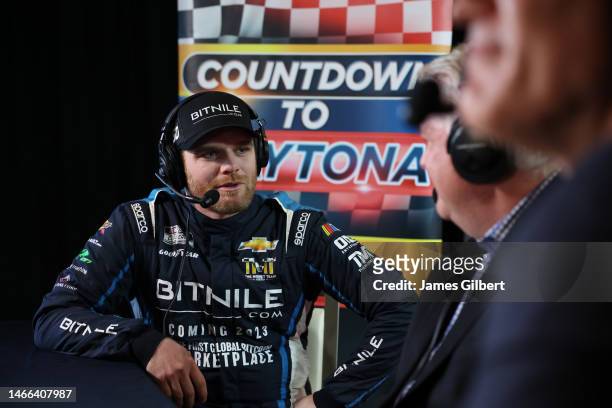 Conor Daly, driver of the BitNile.com Chevrolet, speaks to the media during the NASCAR Cup Series 65th Annual Daytona 500 Media Day at Daytona...