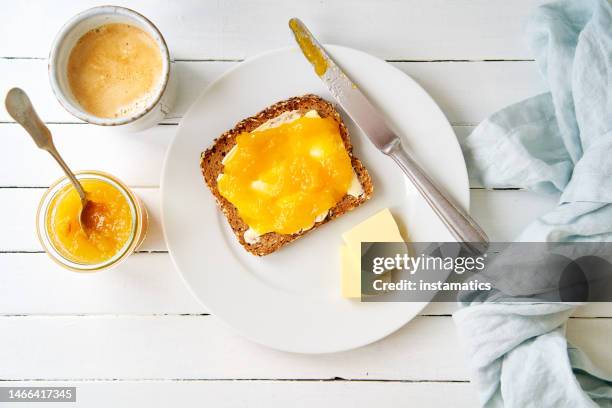 slice of whole grain bread with marmalade - butter coffee stock pictures, royalty-free photos & images