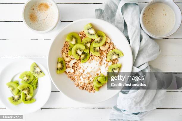 spelt muesli with sliced kiwi - kiwi fruit stock pictures, royalty-free photos & images