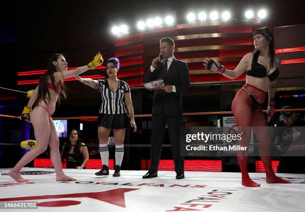 Ziva Fey and Ruby "Booty" Vuitton taunt each other before their match as referee Sarah Wolfe and host and ring announcer A.J. Kirsch look on during...