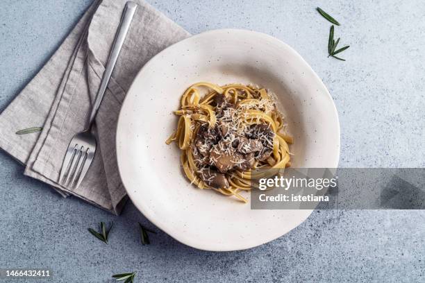 tagliatelle pasta with wild mushrooms, mediterranean cuisine, healthy vegetarian meal, top view - portobello mushroom stock pictures, royalty-free photos & images