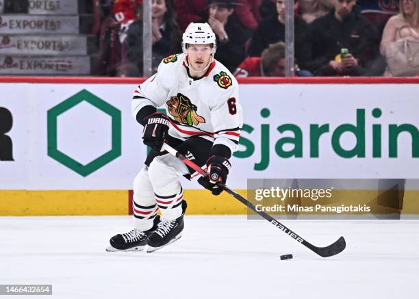 Jake McCabe of the Chicago Blackhawks skates the puck during the first period against the Montreal Canadiens at Centre Bell on February 14, 2023 in...