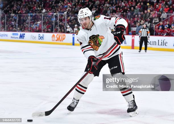 Taylor Raddysh of the Chicago Blackhawks skates the puck during the first period against the Montreal Canadiens at Centre Bell on February 14, 2023...