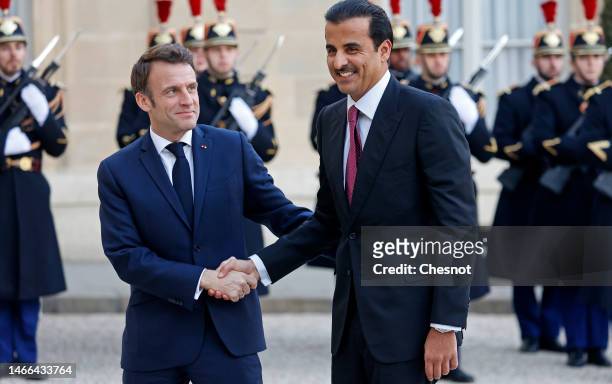 France's President Emmanuel Macron welcomes Qatar's Emir Sheikh Tamim bin Hamad al-Thani prior to their meeting at the Presidential Elysee Palace on...