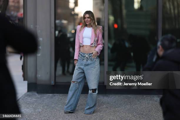 Valentina Ferrer seen wearing Prada shades and a Prada Cleo bag, a patterned cropped blazer, a white shirt, oversized jeans and plateau heels before...