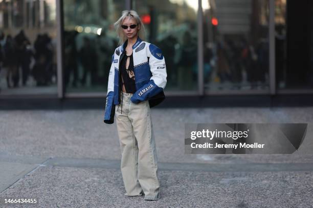 Vanessa Hong seen wearing a light jeans, a leather biker jacket and a black shirt with cutouts before the AREA show on February 11, 2023 in New York...