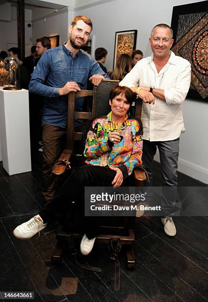 Artist Nancy Fouts poses with gallery owners James Golding and Sean Pertwee attend a private view of 'Artifact: A Solo Exhibition By Nancy Fouts' at...