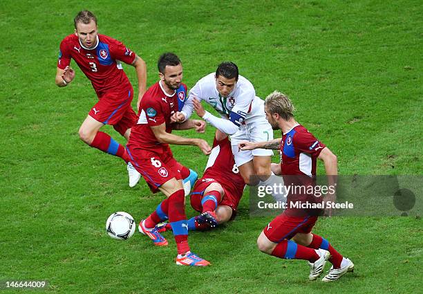 Cristiano Ronaldo of Portugal is tackled by Tomas Sivok and David Limbersky of Czech Republic during the UEFA EURO 2012 quarter final match between...