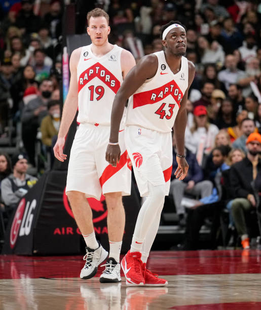 Jakob Poeltl and Pascal Siakam of the Toronto Raptors look on against the Orlando Magic during the second half of their basketball game at the...