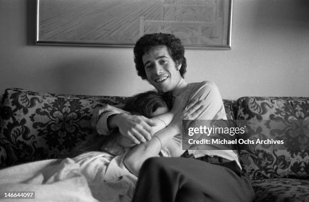 Musician Laura Nyro hides in the chest of music executive David Geffen as they pose for a portrait session on September 13, 1969 in New York, New...