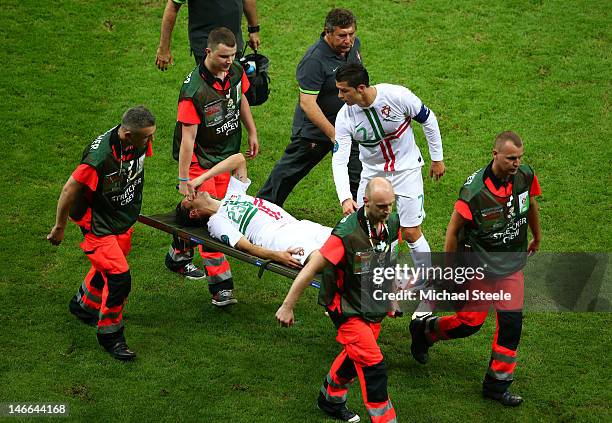 Helder Postiga of Portugal is stretchered off as Cristiano Ronaldo looks on during the UEFA EURO 2012 quarter final match between Czech Republic and...
