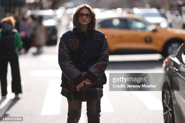 Thassia Naves seen wearing a total Coach look with an oversized college jacket, a patterned shirt and overknee boots before the Coach show on...