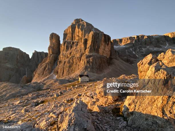 mountain hut in the dolomites at sunrise | south tyrol, italy - rock face stock pictures, royalty-free photos & images