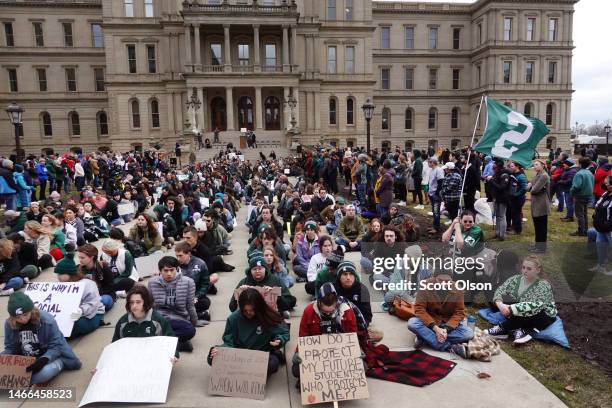 Current and former students from Michigan State University and their supporters attend a rally outside of the state Capitol Building on February 15,...