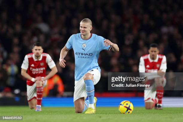 Erling Haaland of Manchester City looks on as players of Arsenal and Manchester City take a knee prior to the Premier League match between Arsenal FC...