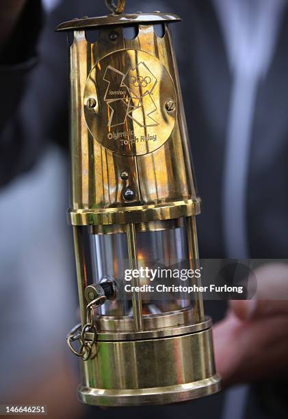 The Olympic Flame burns in a miners Davy Lamp as it travels on board historic steam boat The Tern during a voyage across Lake Windermere on June 21,...
