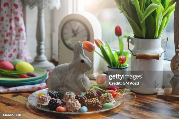 decorating easter bunny lamb cake with icing in domestic kitchen - easter lamb stock pictures, royalty-free photos & images