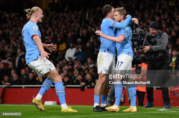 Kevin De Bruyne of Manchester City celebrates with teammate Jack Grealish and Erling Haaland after scoring the team's first goal during the Premier...