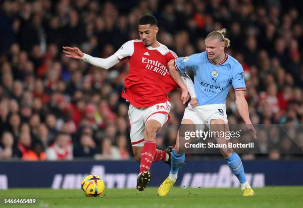 William Saliba of Arsenal is challenged by Erling Haaland of Manchester City during the Premier League match between Arsenal FC and Manchester City...