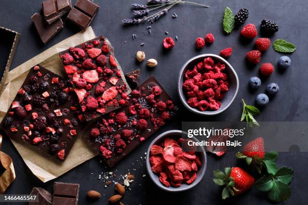 handmade chocolate with lyophilized berry fruits - red pistachio nuts stock pictures, royalty-free photos & images