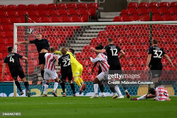 Phil Jagielka of Stoke City looks on as his header beats Martyn Waghorn of Huddersfield Town to score the first goal during the Sky Bet Championship...