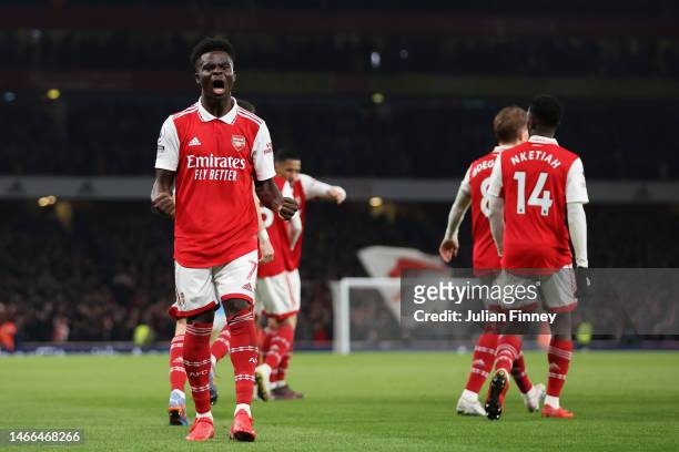 Bukayo Saka of Arsenal celebrates after scoring the team's first goal from a penalty kick during the Premier League match between Arsenal FC and...