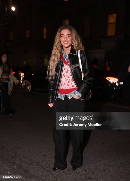 Emili Sindlev seen wearing a black leather jacket, a blue and white blouse, red and white top and black pants outside Tory Burch Show during New York...