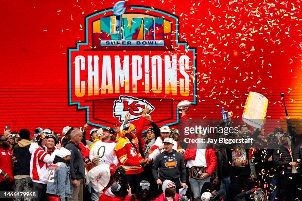 Patrick Mahomes of the Kansas City Chiefs holds up the MVP trophy while celebrating with teammates during the Kansas City Chiefs Super Bowl LVII...