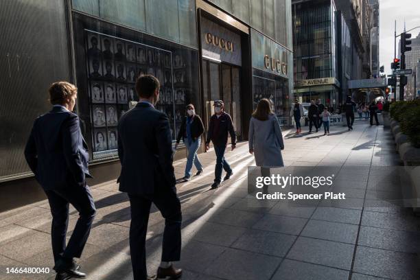 People walk along 5th Avenue in Manhattan, one of the nation's premier shopping streets on February 15, 2023 in New York City. The Commerce...